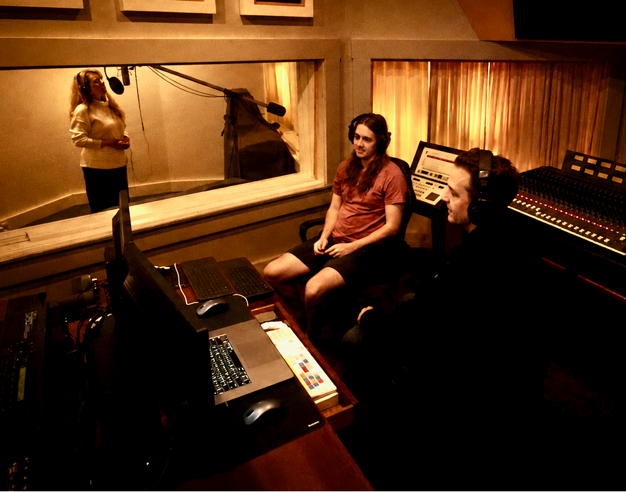 Artists collaborating in the control room at Big Planet Studio